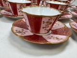 several cups and saucers are lined up on a table