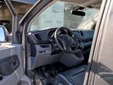 the interior of a truck with the door open and the driver ' s seat down