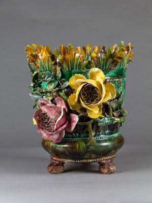 a vase that has flowers in it on a stand