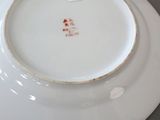 a white plate with a red design on it
