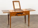 an old wooden desk with a mirror on top of it