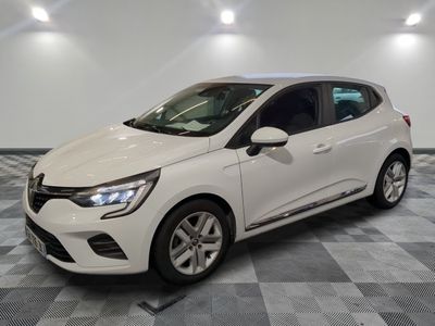 a white car is parked in a room with a checkered floor
