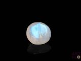 an image of a white moons stone on a black surface