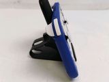 a blue and black cell phone holder on a white table