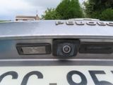 a close up of a car ' s license plate with a camera attached to it