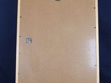 a wooden easel with a brown canvas on it against a blue backdrop