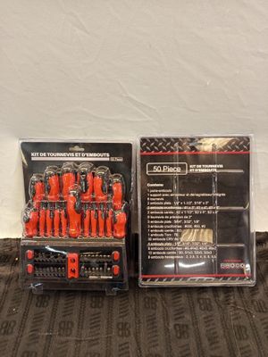 two different types of screwdrivers are sitting on a bed