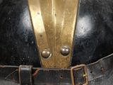 an old fashioned helmet with a leather belt is on display