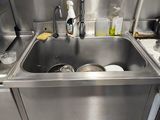 a sink in the kitchen with a lot of dishes in it