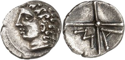 a silver coin with an image of a man and a cross on it