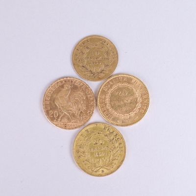 four different types of gold coins on a white surface