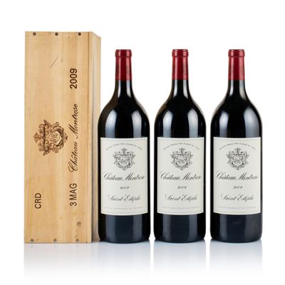 three bottles of wine and a wooden box on a white surface