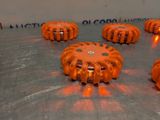 many orange lights that are sitting on a metal surface