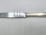 a close up of a knife on a table with a white background