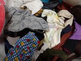 a pile of clothes on the floor in a room
