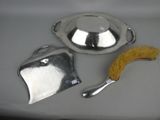 a silver plate with a brush and a bowl on it