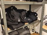 a lot of clothes on the shelves in the store