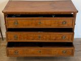 a wooden dresser with three drawers on top of it