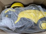 a cardboard box with a yellow and black toy inside of it