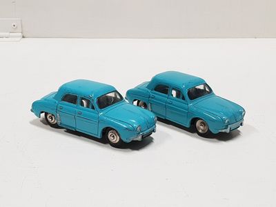 two toy cars that are sitting on a white surface