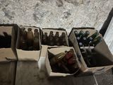 many bottles of beer in boxes on a table