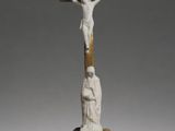 statue of a crucifix with a man on a cross on a pedestal