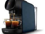 a blue coffee machine with two cups of coffee in front of it