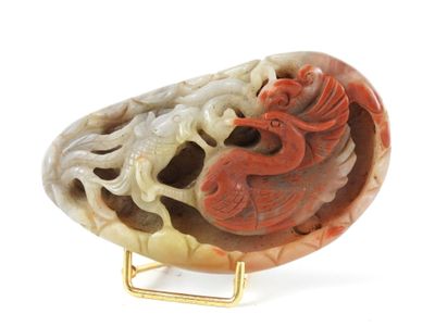 a red and white stone with a dragon on it