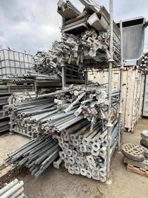 piles of steel pipes and poles stacked on top of each other