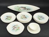 six plates and a bowl with fish on them