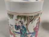 a small cup with a lid sitting on a table