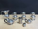 silver plated tea and coffee set on a wooden table