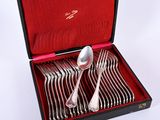 silverware in a case with a red lining on a white surface