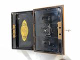 a small black box with a gold medal in it