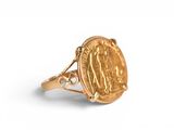 a gold ring with a coin in the middle of it