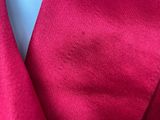 a close up of a red suit with a blue tie