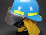 a close up of a helmet and gloves on a mannequin head