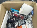 a cardboard box full of electronic equipment on the floor