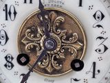 a close up of a gold clock with numbers on it