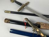 several different types of swords are displayed on a white surface