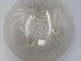 a clear glass bowl with a flower design on it