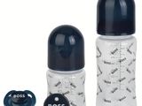 a close up of a baby bottle with a pacifier and a bottle opener