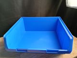 a blue plastic bin sitting on top of a wooden table