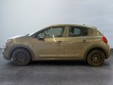 a picture of a beige car parked in a garage