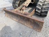 a tractor that is sitting in the dirt with a plow attached to it