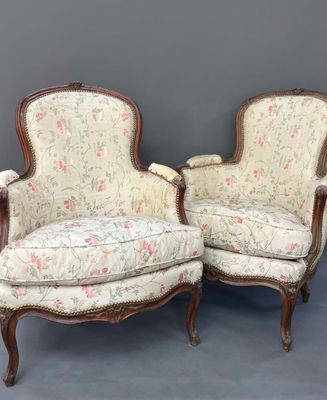 pair of antique french style chairs with floral upholstered upholstered cushions