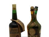 two bottles of liquor sitting next to each other on a table