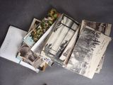 a pile of old photos on a table next to a pair of shoes