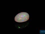 a white oplite in the dark with a black background