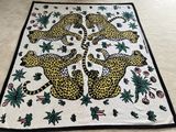 a blanket that has a picture of a group of leopards on it